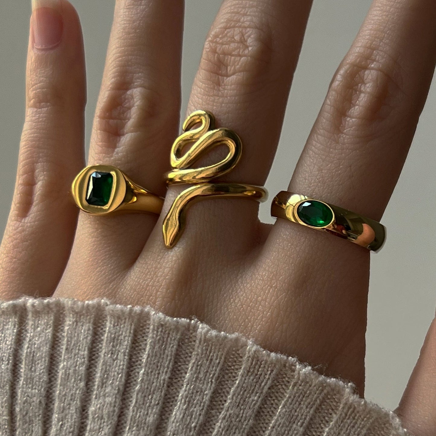 Gold ring with shimmering gemstone in green