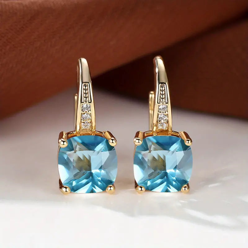 Claudine – Golden Hoop Earrings with Mystical Sapphire