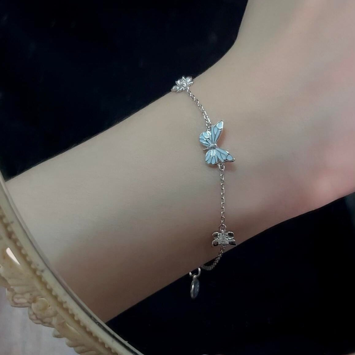 Women's Butterfly Bracelet with Glowing Pendant and Floral Details