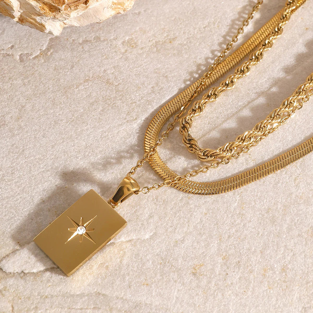 Women's Multilayered Necklace with Three Fine Chains and Stone Accents