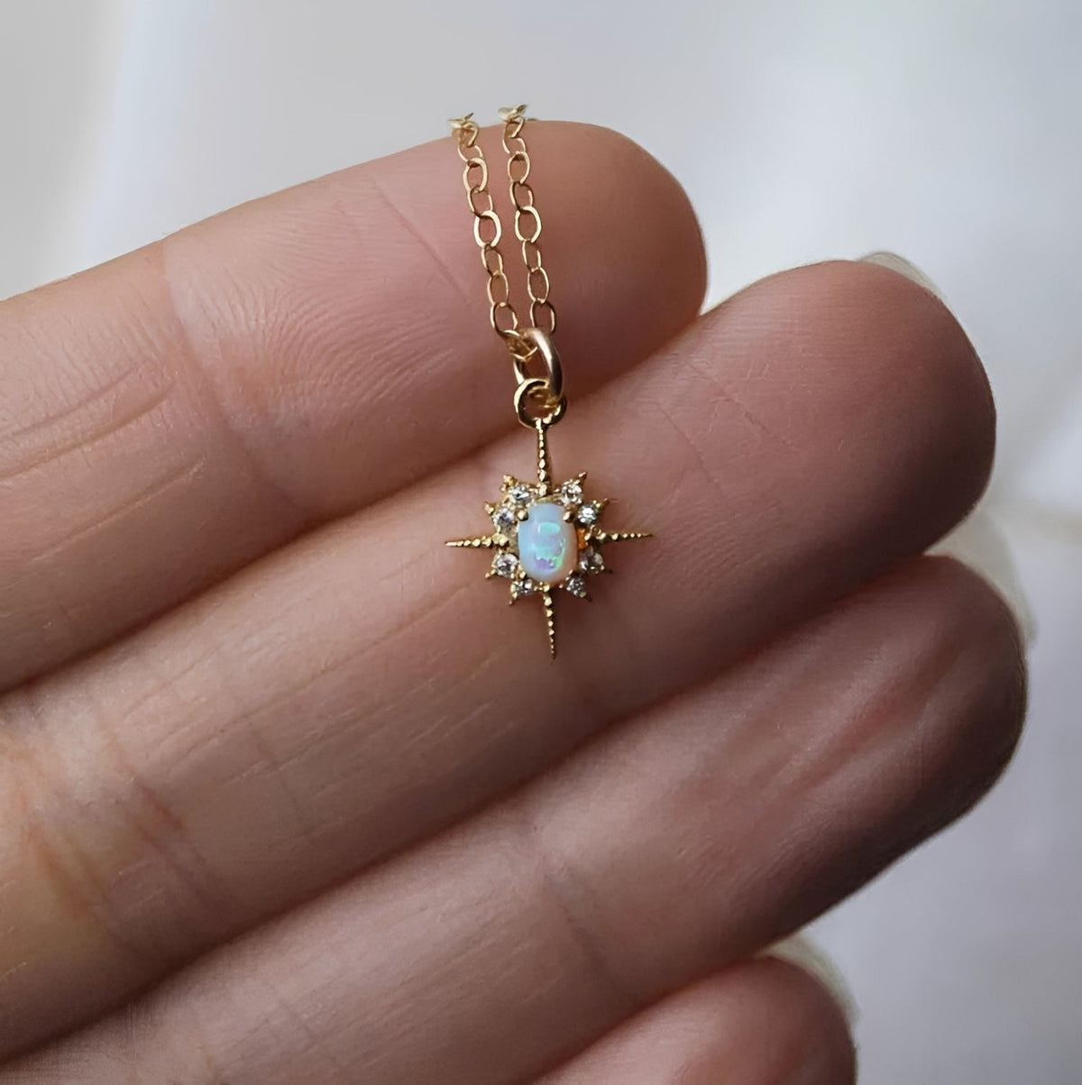 Women's Pendant Necklace with Oval Center Stone and Star Ray Design