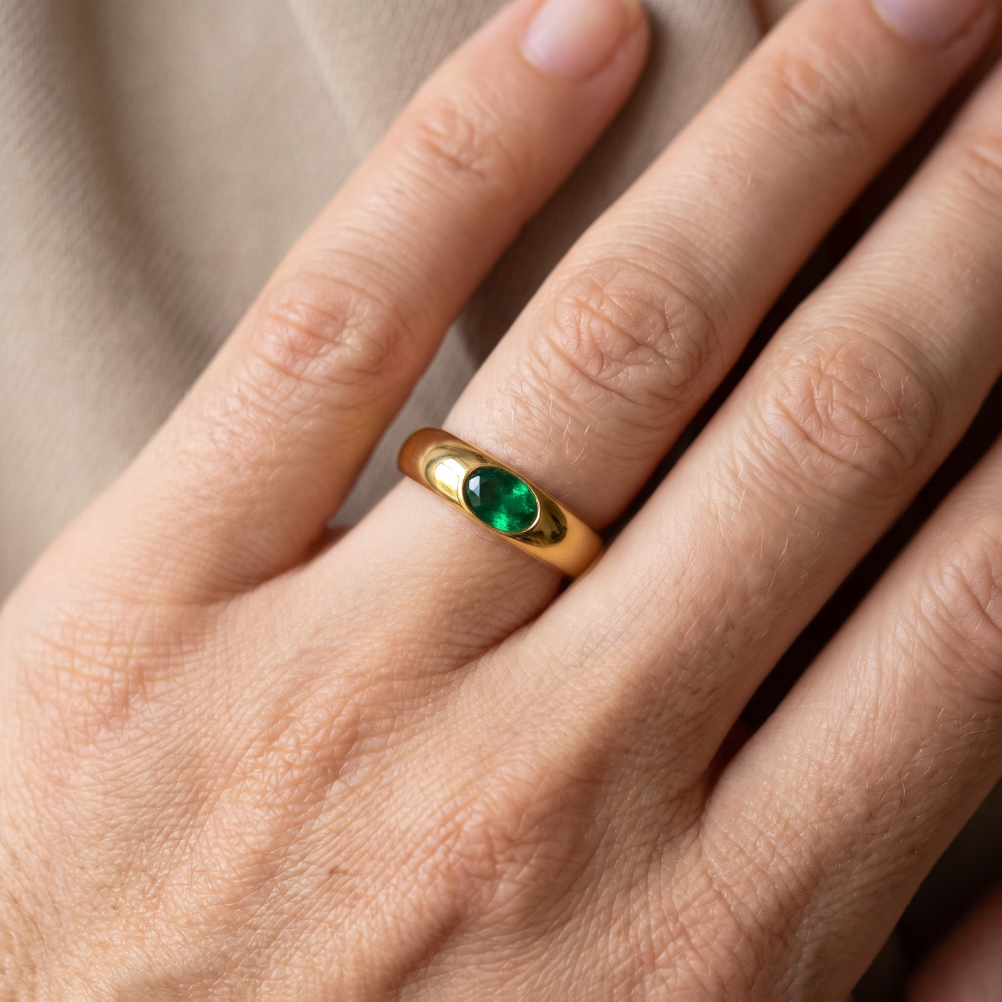 Gold ring with shimmering gemstone in green