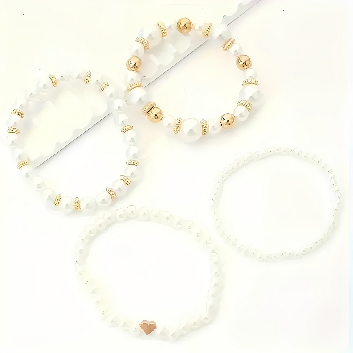 Women's 4-piece stackable bracelet set with pearl details and heart charm