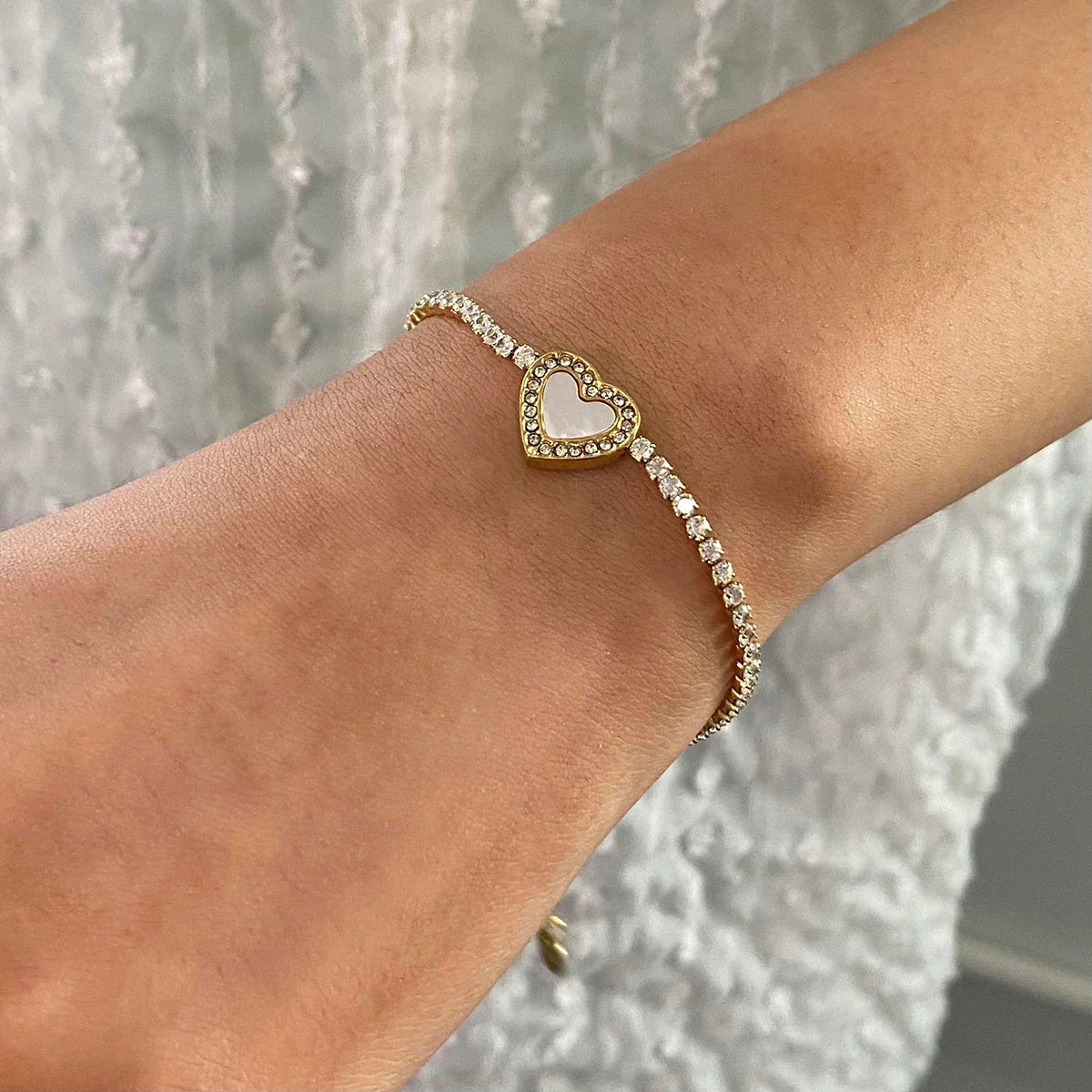 Women’s Heart Bracelet with Continuous Stone Setting and Central Heart Motif