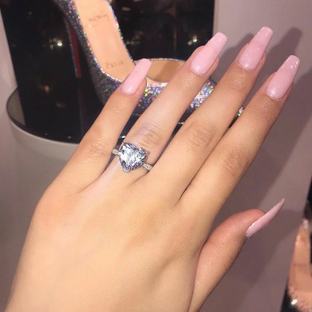 Women's Heart Ring with a Single Stone and Faceted Heart Design