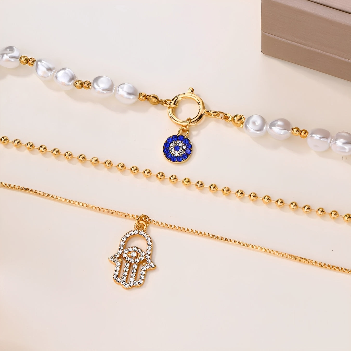 Nadia – Multi-Strand Pearl Necklace with Hamsa Hand